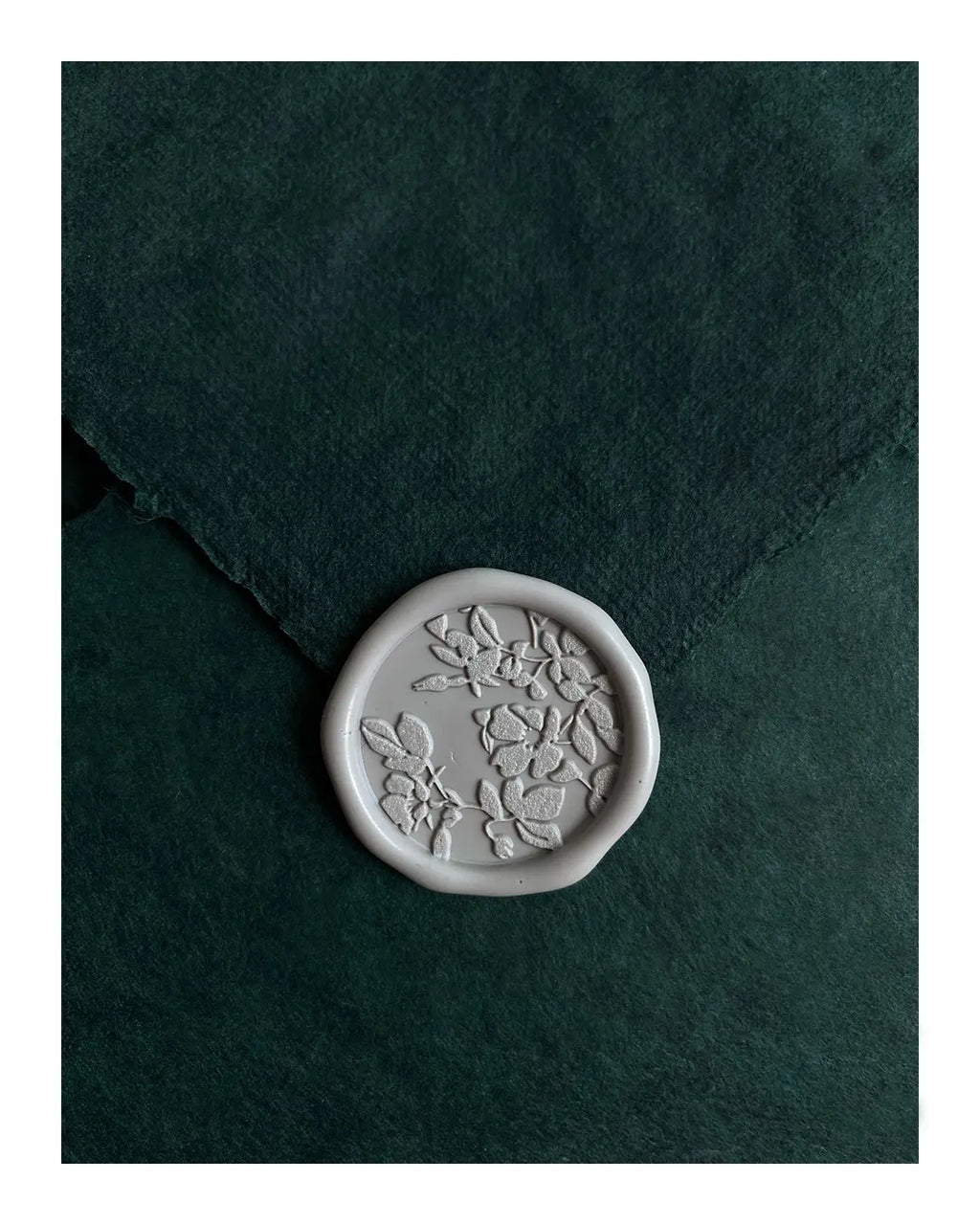 Luxury gift certificate with botanical floral wax seal impression on textured teal background